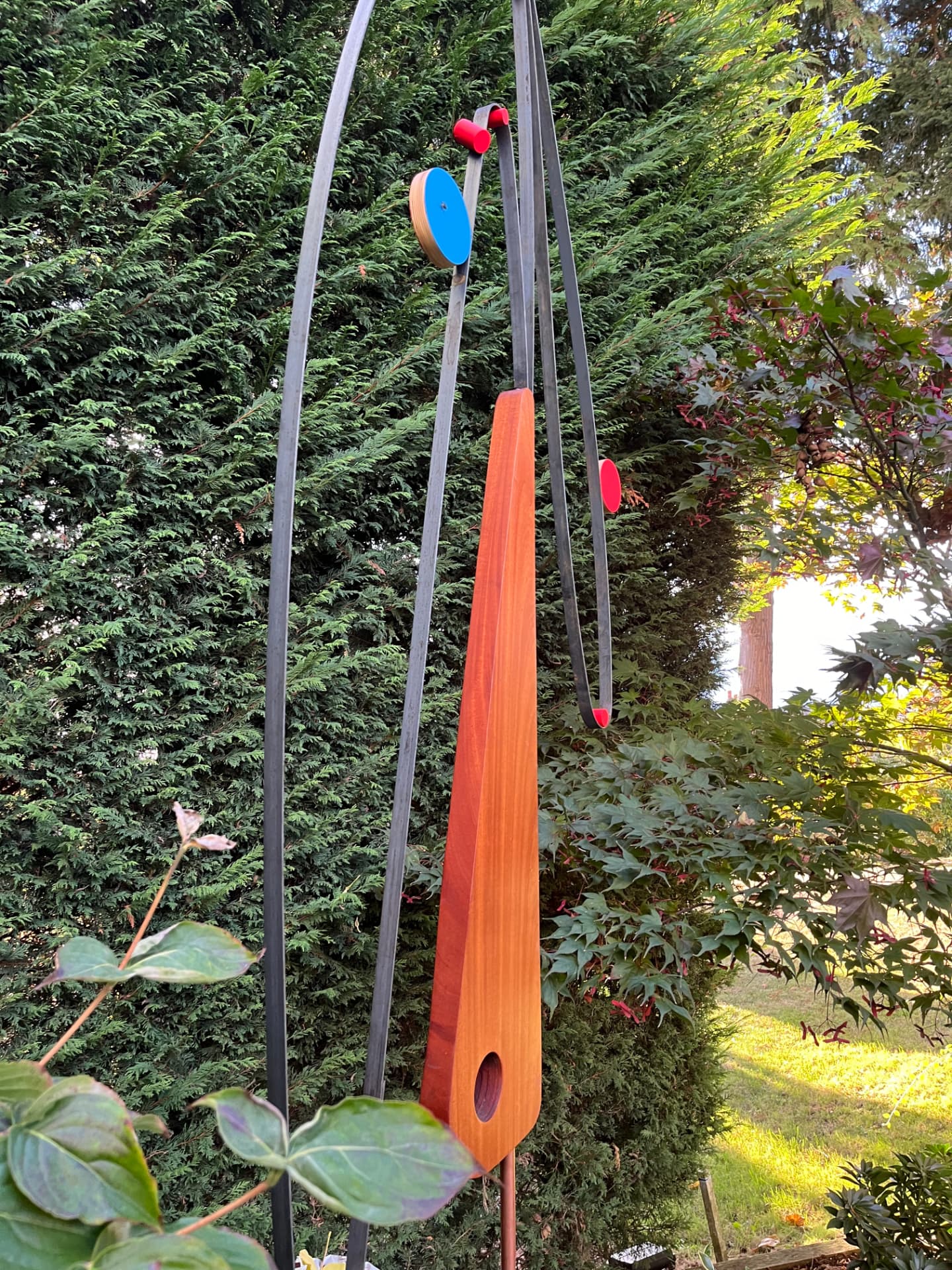 Garden kinetic — cedar blade and steel arcs