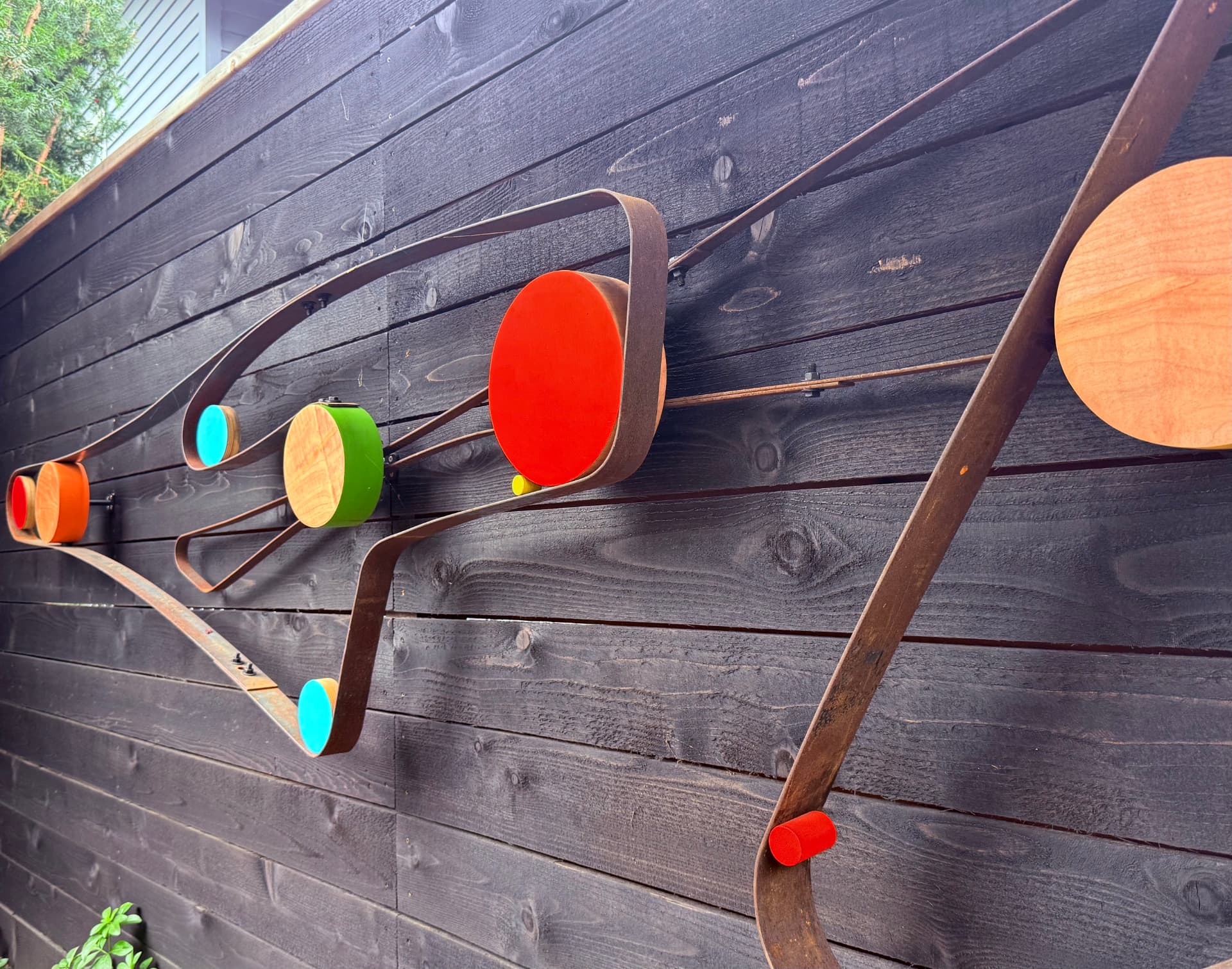Outdoor wall piece — steel ribbon and painted discs